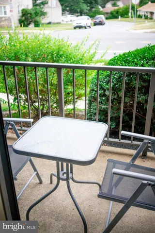 a view of a balcony with a table and chairs