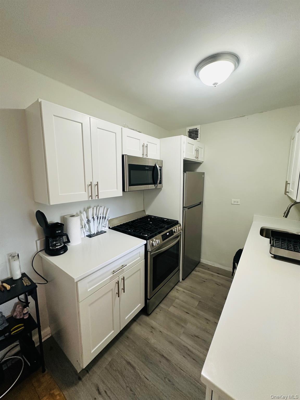 3121 Middletown Road, Unit 6H Bronx, NY 10461 - Photo 16 of 24 a kitchen with a stove a sink and a microwave