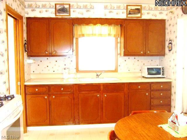 13634 Carpenter Road Garfield Heights, OH 44125 - Photo 8 of 24 The huge eat in kitchen is a cook's delight! Look at all those cabinets and all that prep space! Pristine condition!