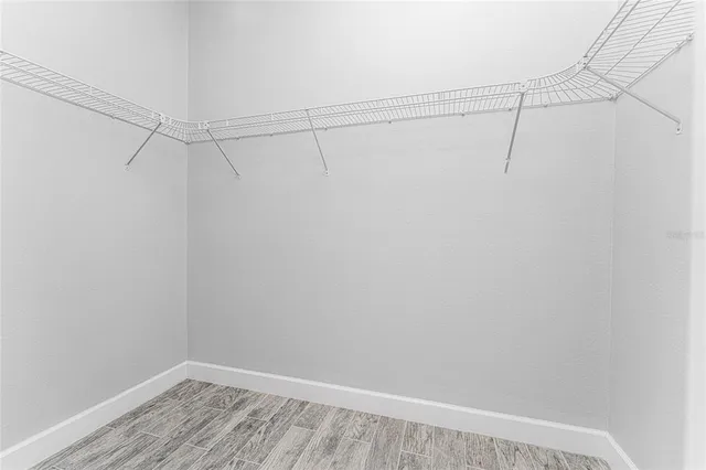 a view of a hallway with a ceiling fan