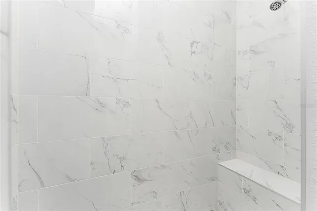 a view of a glass door with a balcony from a window