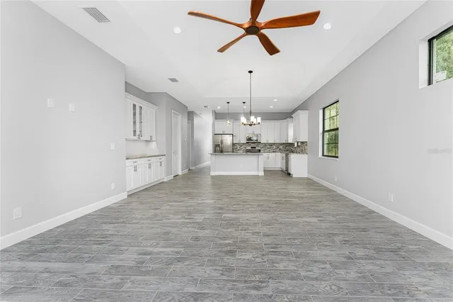a view of a kitchen with a sink and wooden floor