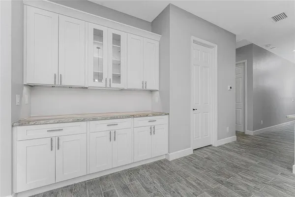 a large kitchen with stainless steel appliances a large counter top a stove a sink dishwasher and a refrigerator