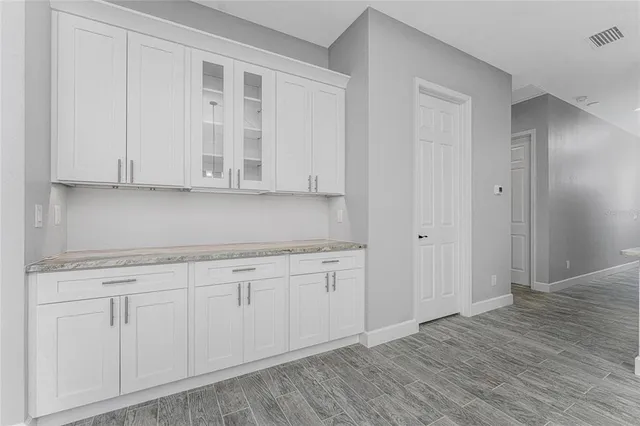 a large kitchen with stainless steel appliances a large counter top a stove a sink dishwasher and a refrigerator