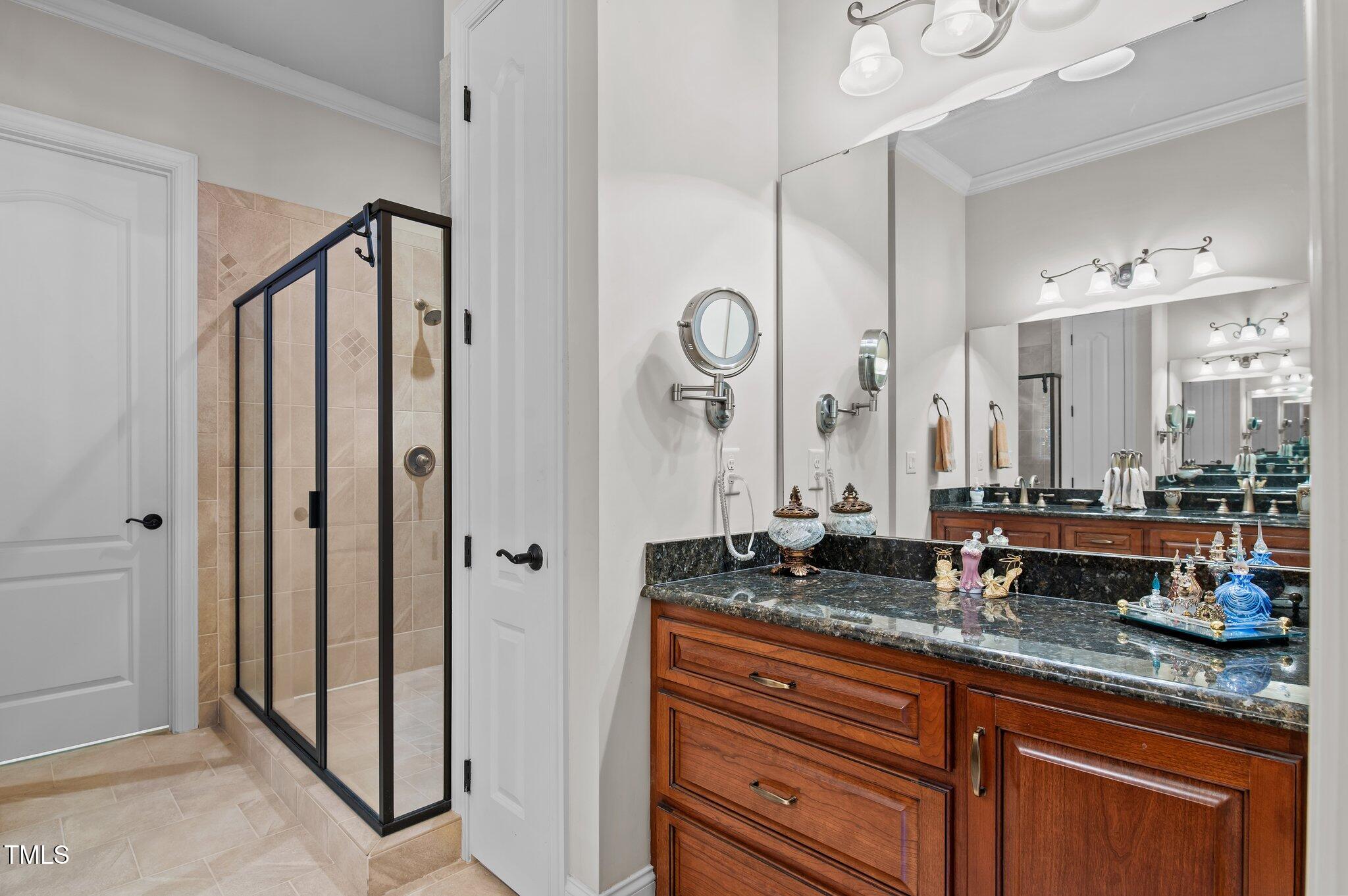 901 Edgewater Drive Garner, NC 27529 - Photo 22 of 72 a bathroom with granite countertop double vanity and a mirror