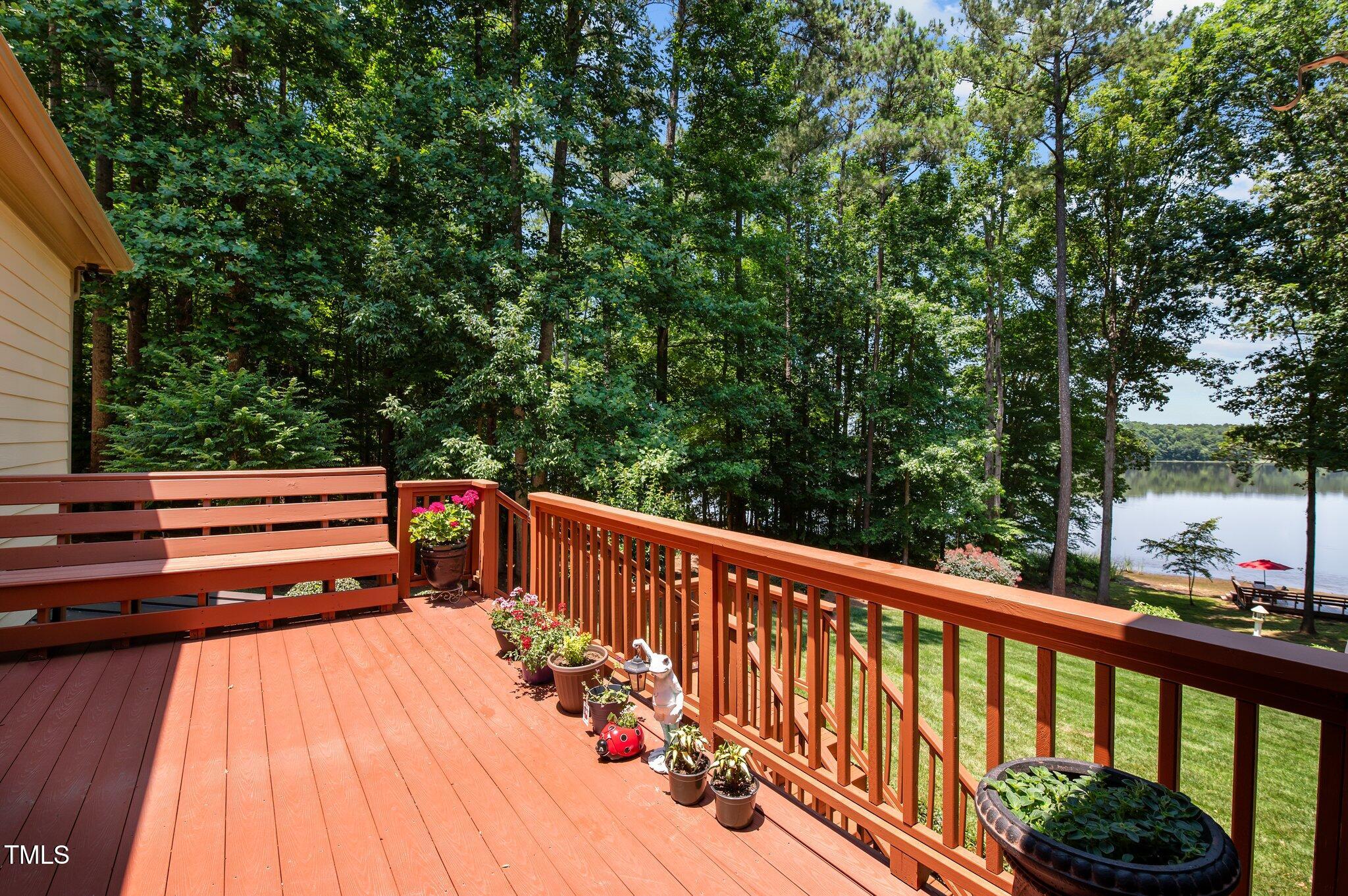 901 Edgewater Drive Garner, NC 27529 - Photo 23 of 72 a view of balcony with furniture and trees in the background