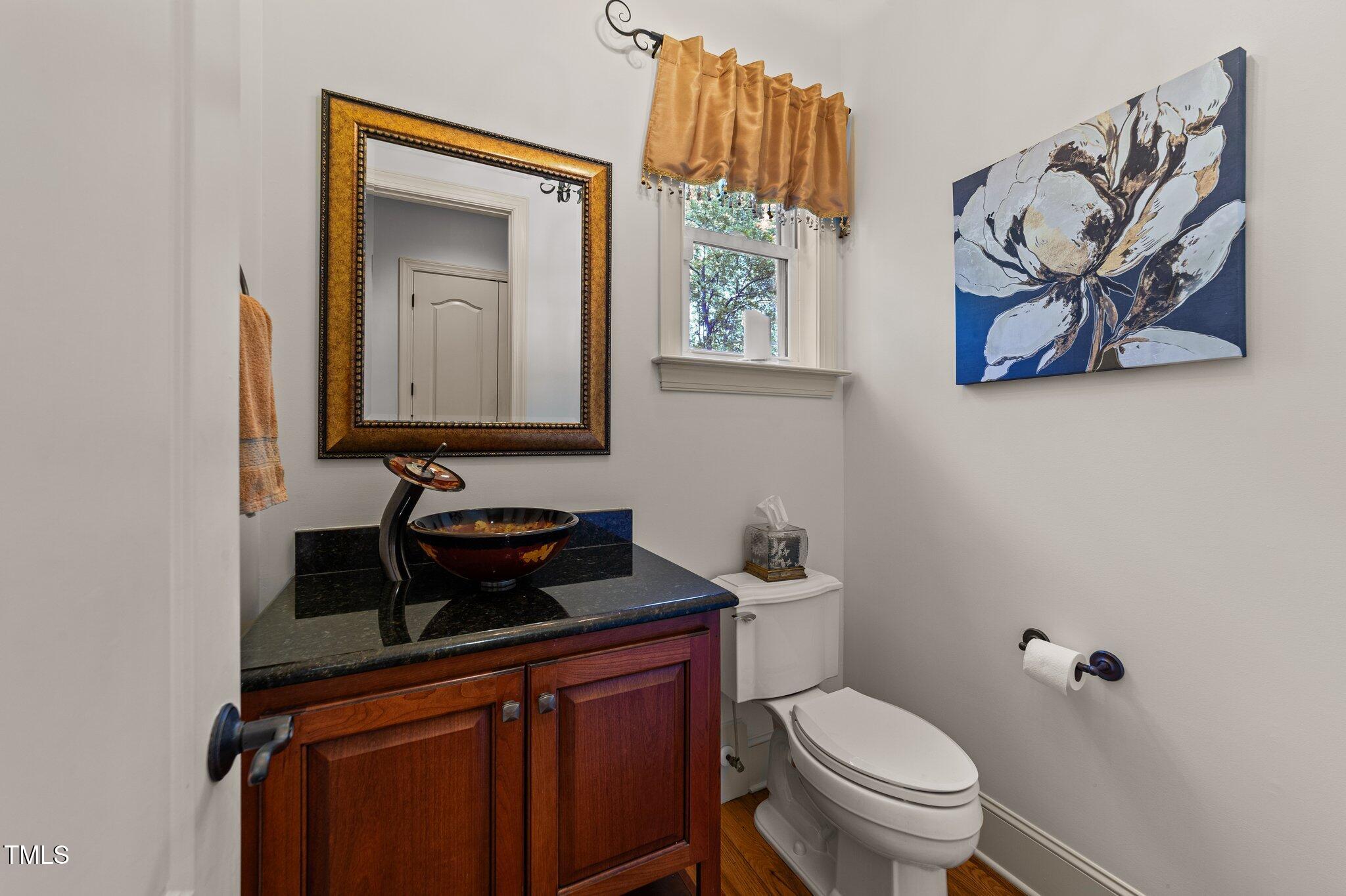 901 Edgewater Drive Garner, NC 27529 - Photo 24 of 72 a bathroom with a toilet a sink and mirror