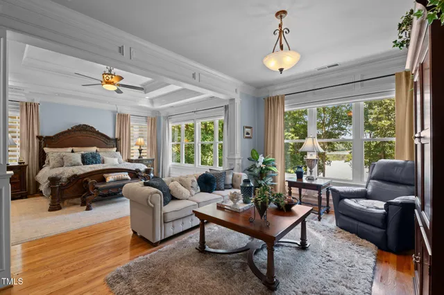 a living room with a bed furniture and a window
