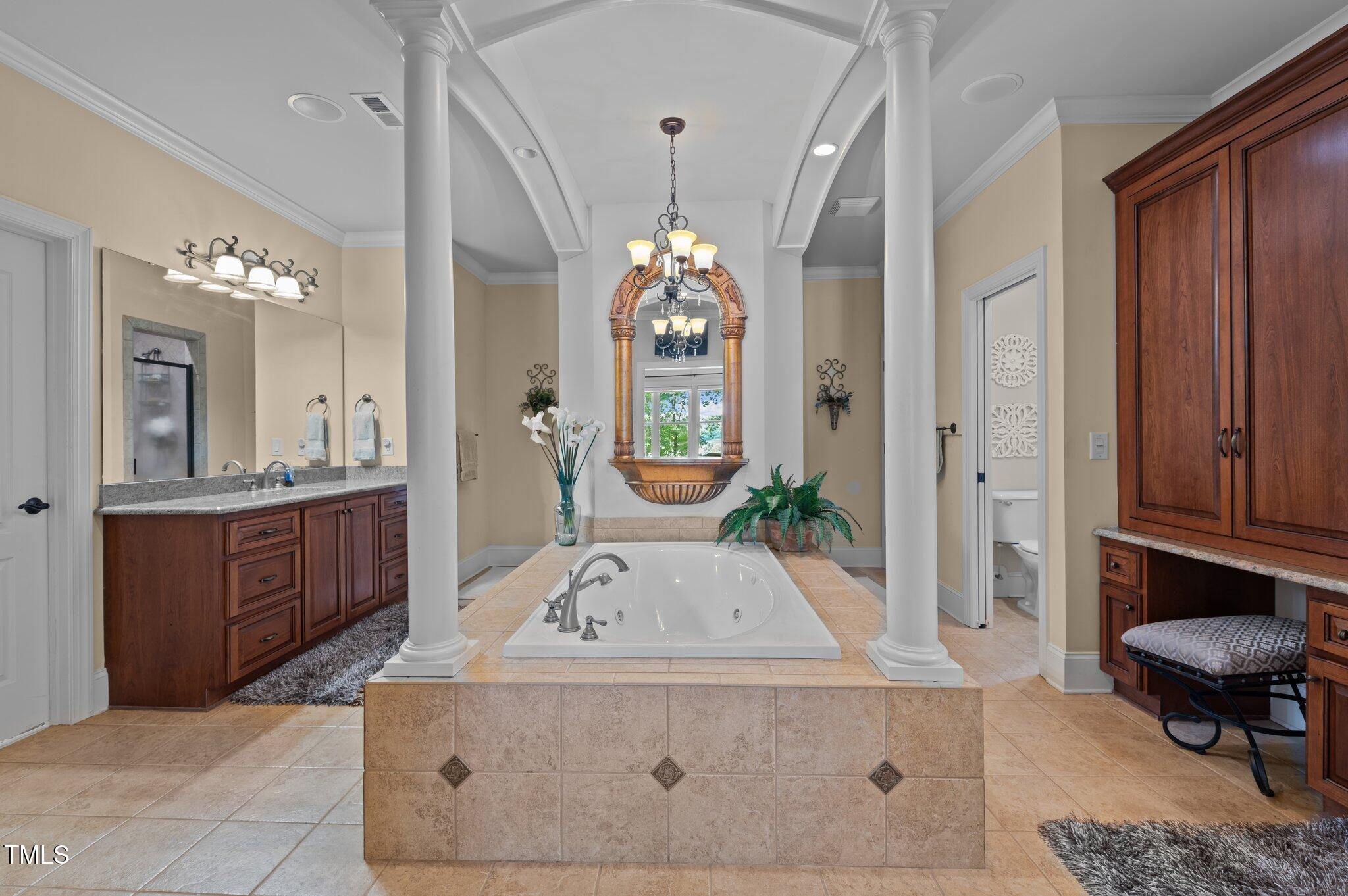 901 Edgewater Drive Garner, NC 27529 - Photo 33 of 72 a bathroom with a sink a vanity a mirror and a bathtub