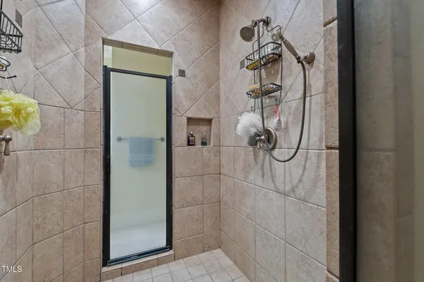 a bathroom with a granite countertop sink a toilet a mirror and shower