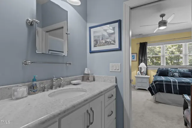a living room with furniture a fireplace and a chandelier