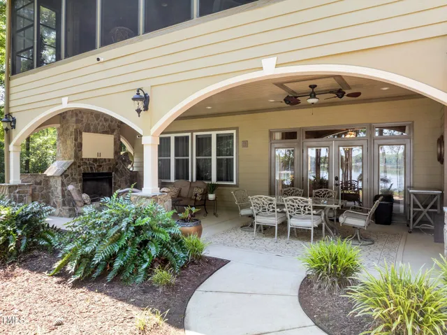 a view of a house with a yard balcony and sitting area