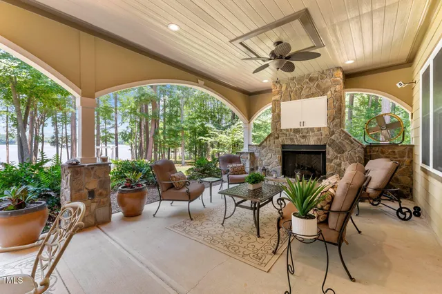 a view of house with yard and trees in the background