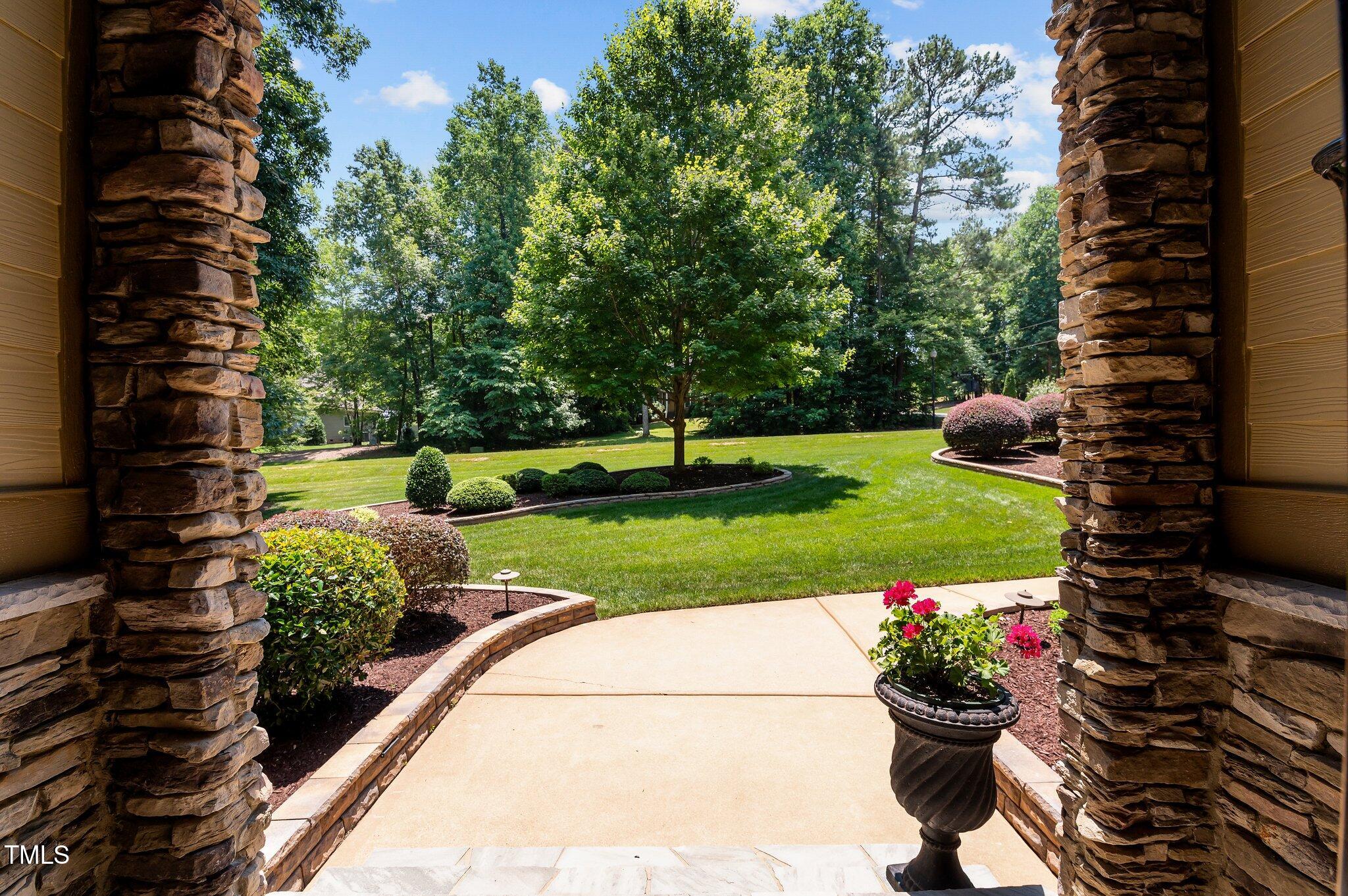 901 Edgewater Drive Garner, NC 27529 - Photo 65 of 72 a view of a garden with a fountain