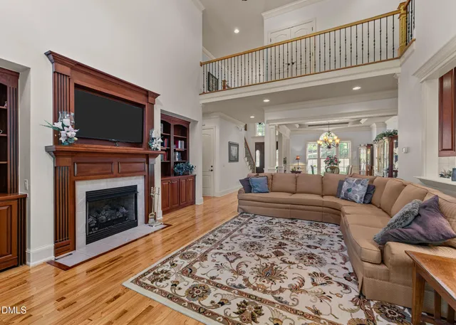 a living room with fireplace furniture and a large window