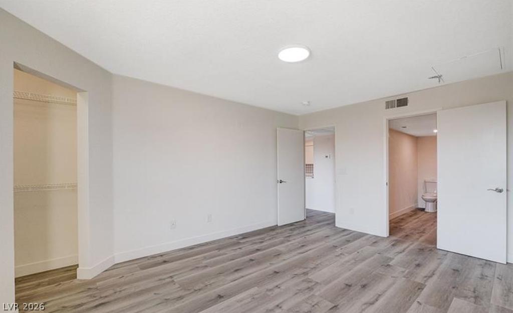 8101 West Flamingo Road, Unit 2014 Las Vegas, NV 89147 - Photo 8 of 13 A spacious layout showcases modern vinyl plank flooring and an integrated closet design.
