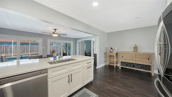 a kitchen with sink refrigerator and cabinets