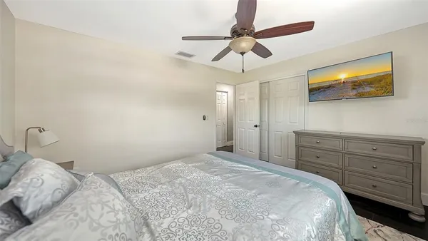 a bedroom with a bed and a flat screen tv