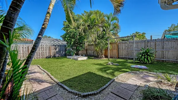 a view of a house with backyard and sitting area