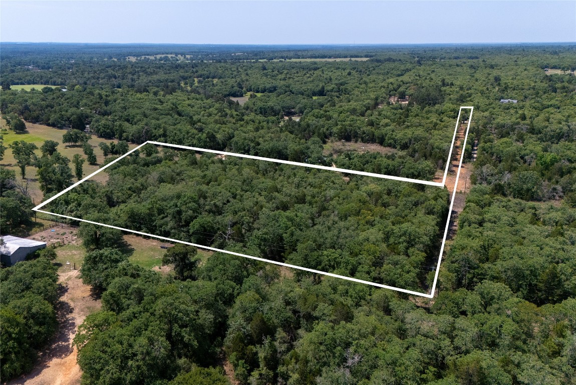 Tbd Whipperwill Lane Elgin, TX 78621 - Photo 1 of 19 a view of a green field with a view of a forest