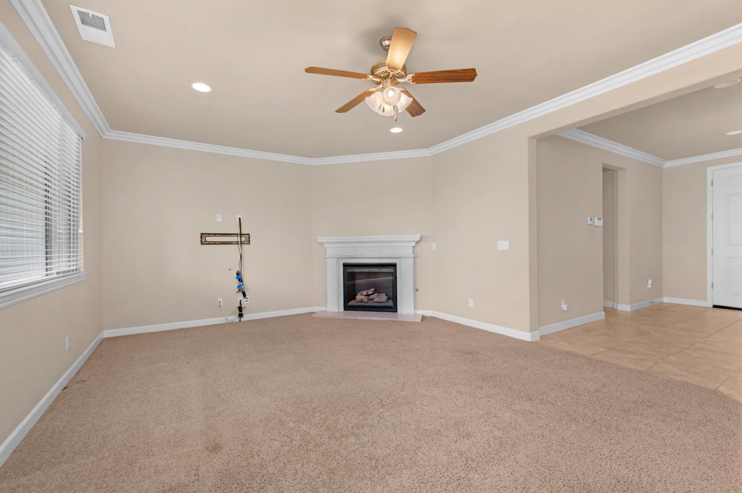 3267 Portals Avenue Clovis, CA 93619 - Photo 18 of 69 a view of an empty room with a fireplace and a window