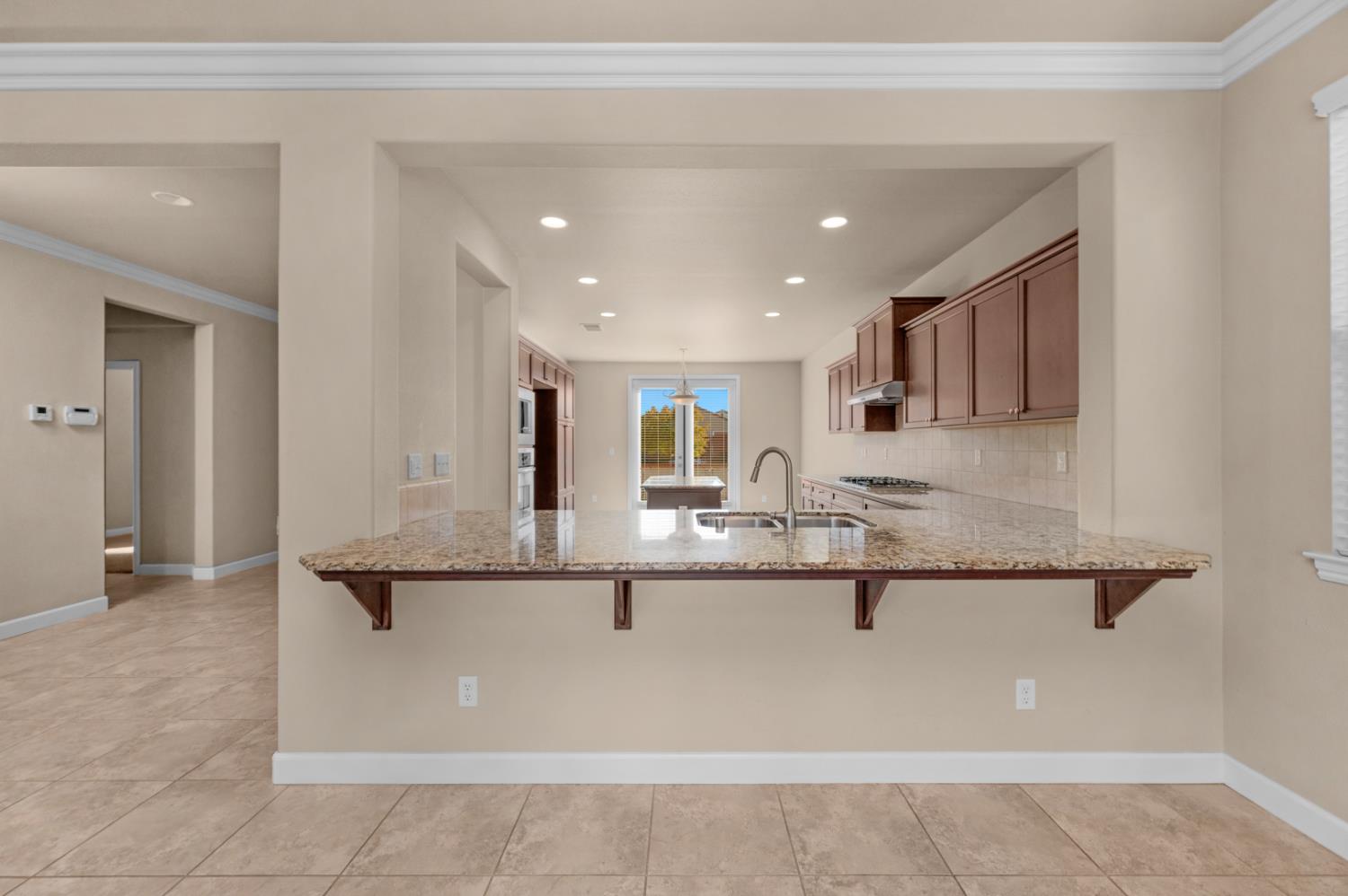 3267 Portals Avenue Clovis, CA 93619 - Photo 25 of 69 a kitchen with kitchen island granite countertop a sink and cabinets