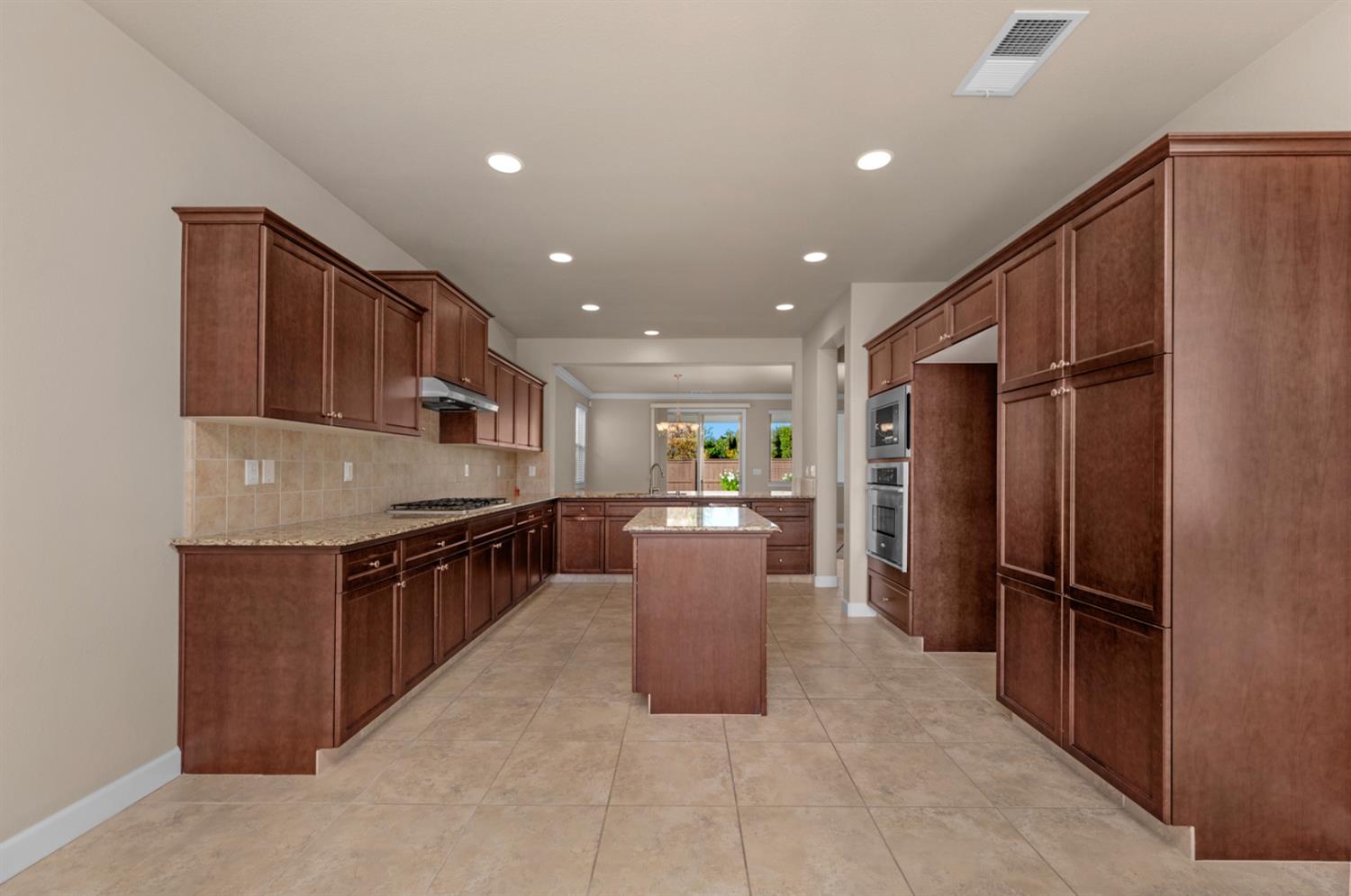 3267 Portals Avenue Clovis, CA 93619 - Photo 30 of 69 a kitchen with stainless steel appliances granite countertop a refrigerator and a stove