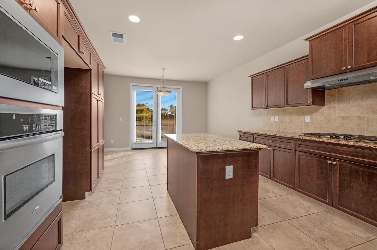 3267 Portals Avenue Clovis, CA 93619 - Photo 3 of 69 a kitchen with stainless steel appliances granite countertop a stove a sink and a refrigerator