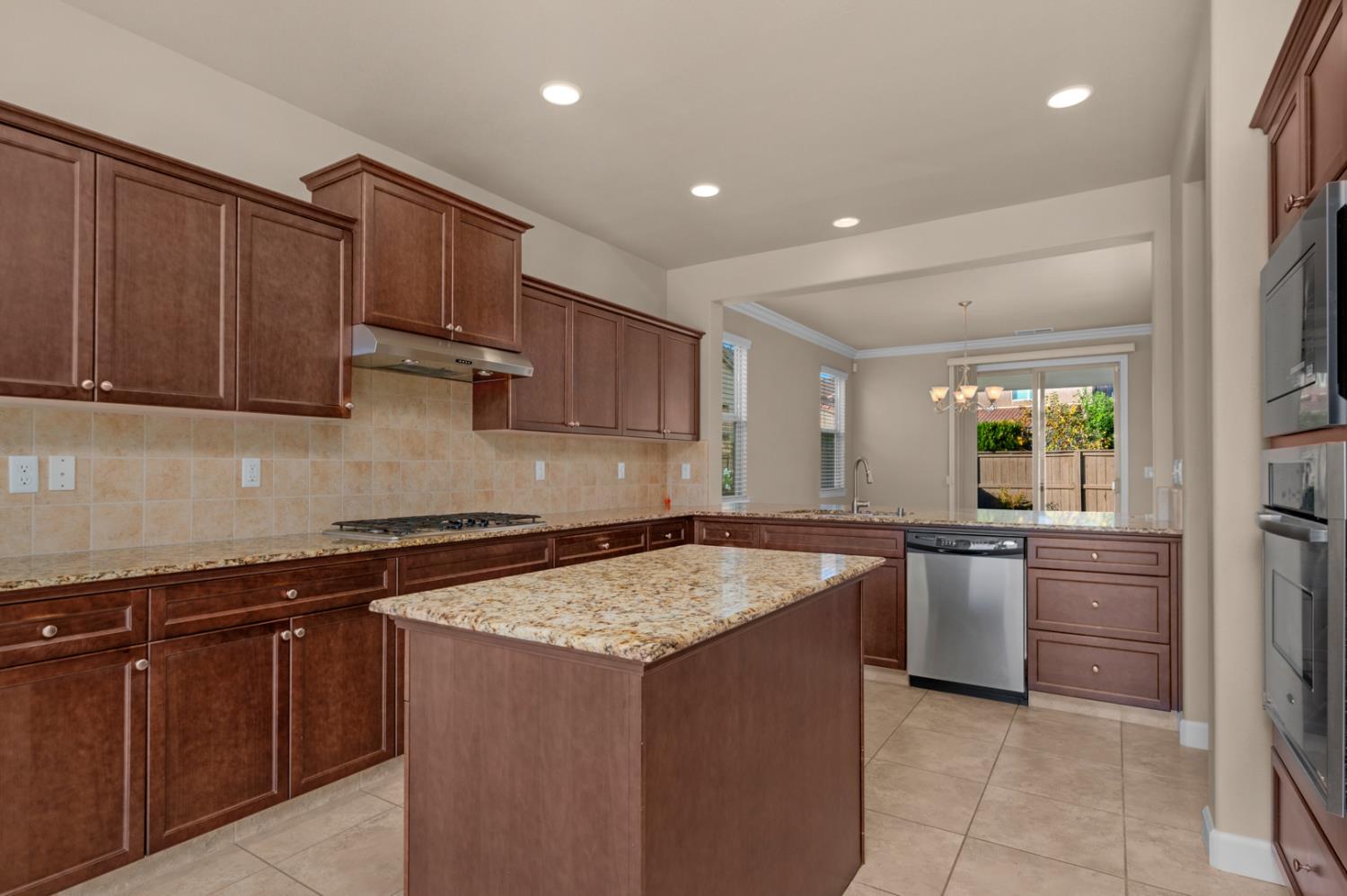 3267 Portals Avenue Clovis, CA 93619 - Photo 31 of 69 a kitchen with stainless steel appliances granite countertop a sink and stove