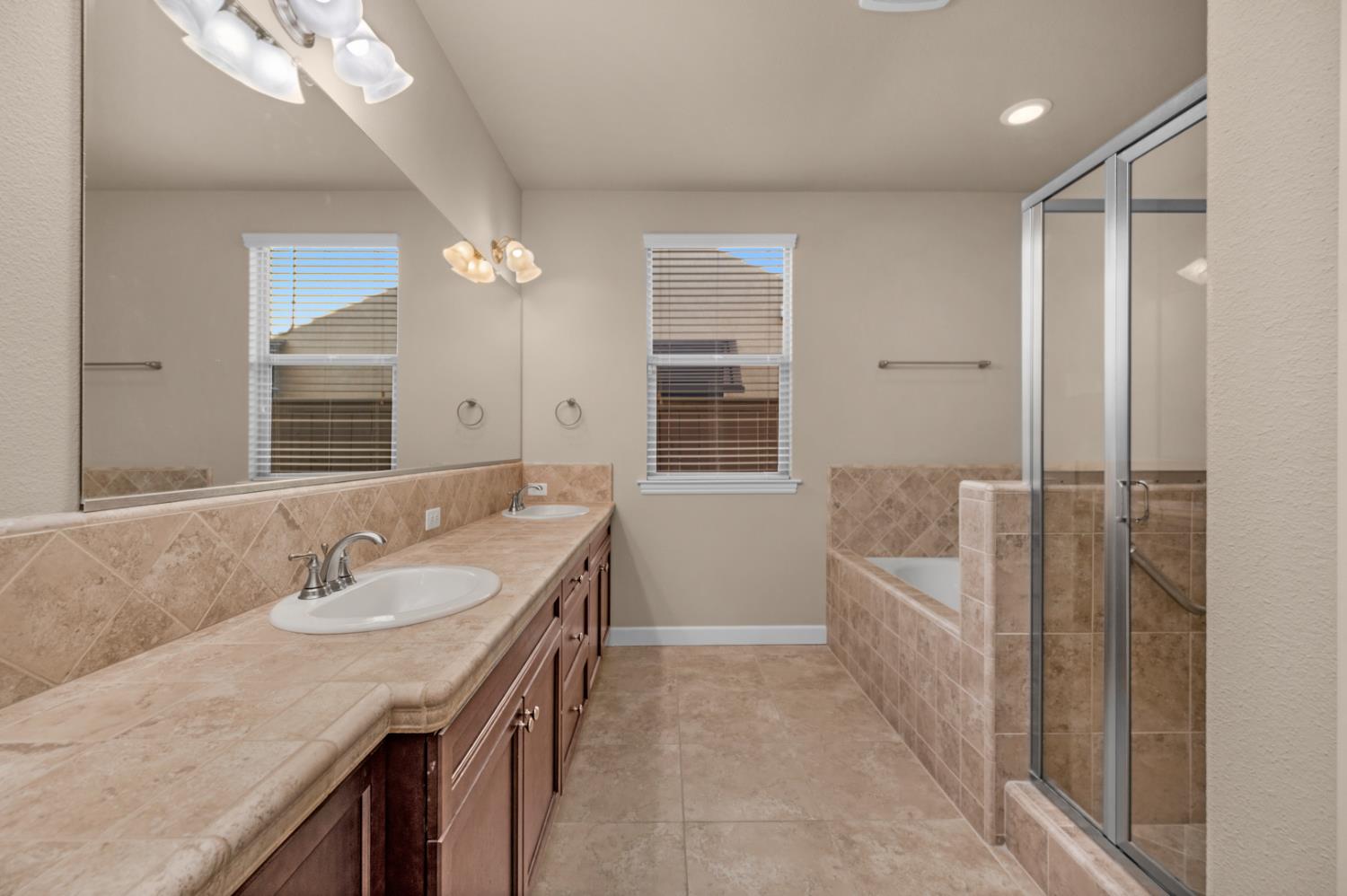 3267 Portals Avenue Clovis, CA 93619 - Photo 6 of 69 a spacious bathroom with a granite countertop sink a shower and a mirror