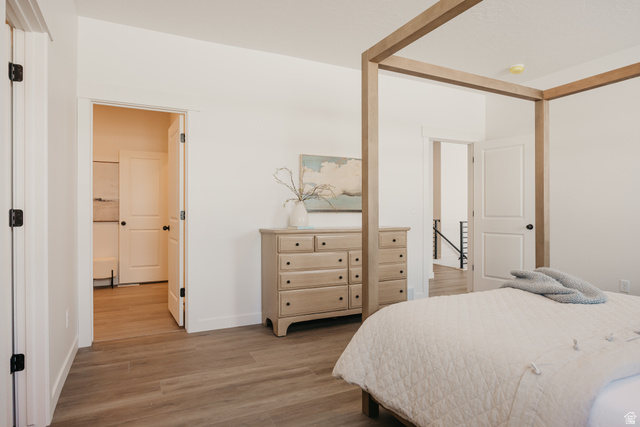 4595 North Fallow Way, Unit 511 Eagle Mountain, UT 84005 - Photo 24 of 32 Bedroom with light wood-style floors and baseboards