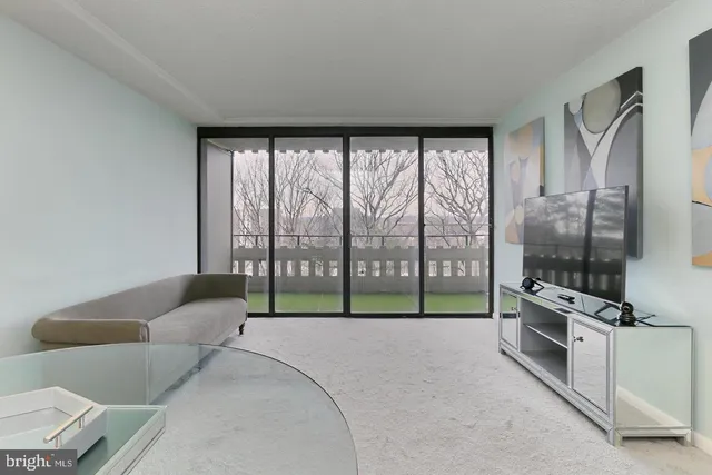 a bedroom with furniture and a flat screen tv