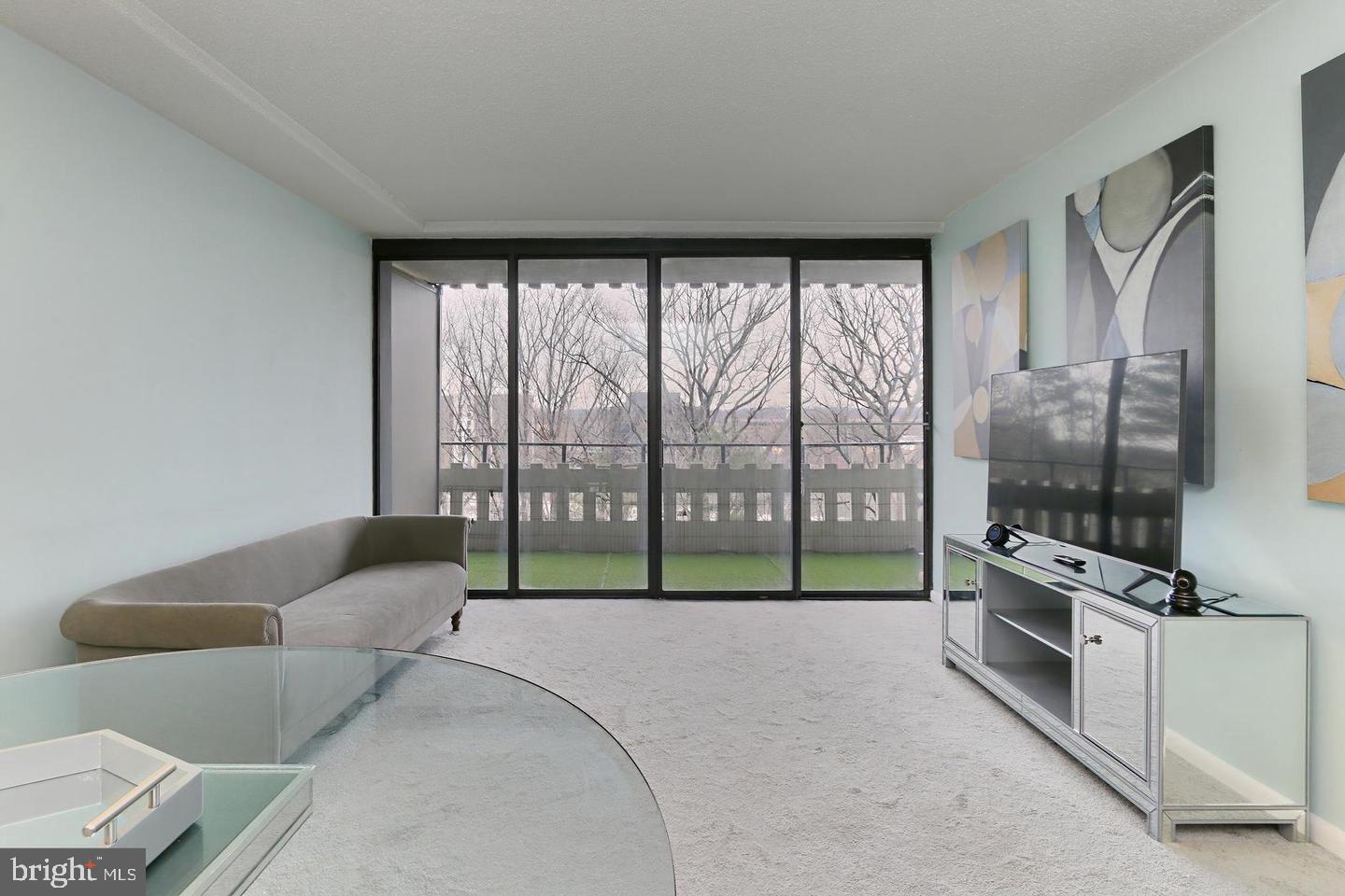 6301 Stevenson Avenue, Unit 914 Alexandria, VA 22304 - Photo 4 of 9 a bedroom with furniture and a flat screen tv