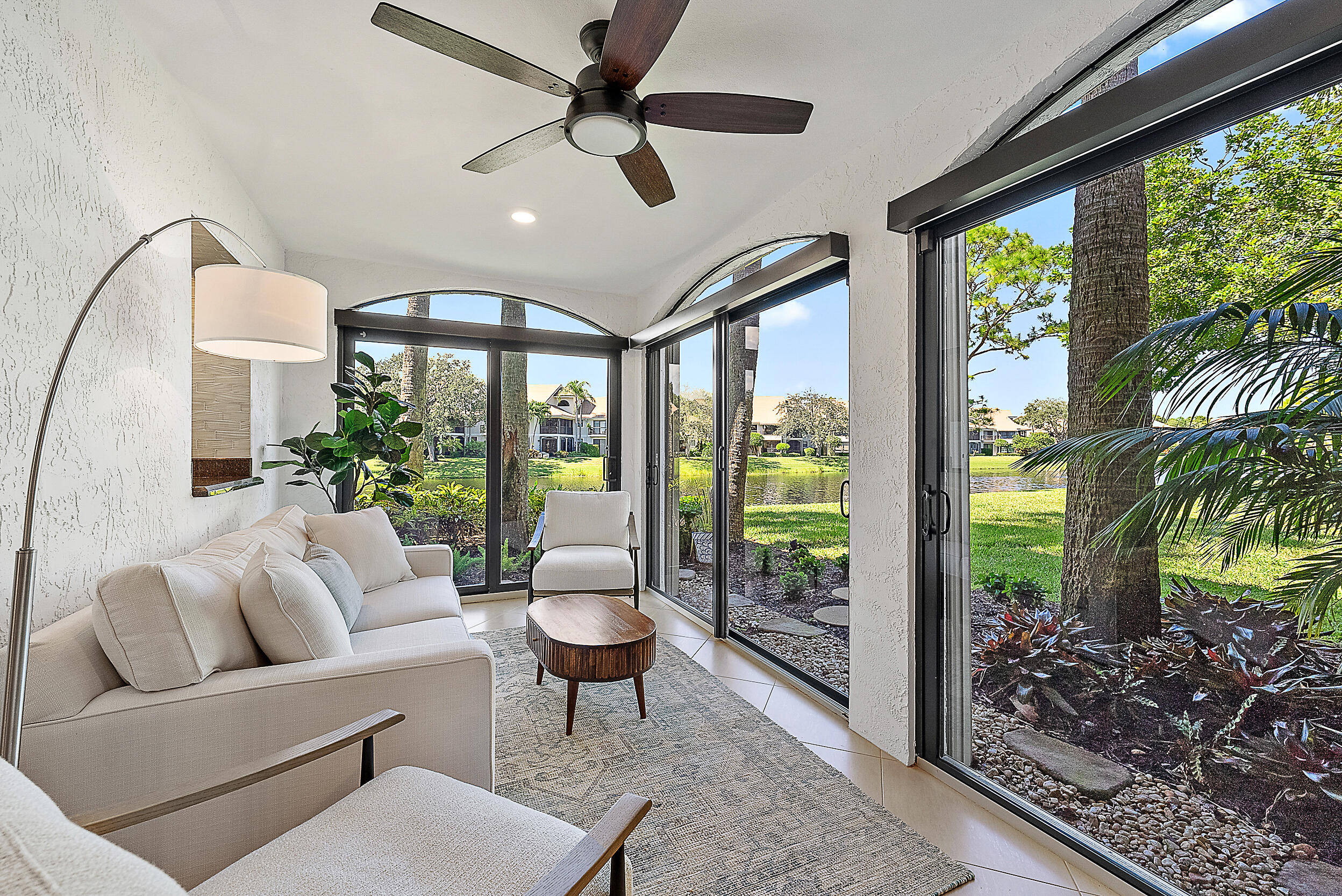 16647 Traders Crossing North, Unit 126 Jupiter, FL 33477 - Photo 11 of 45 a living room with furniture a lamp and a potted plant