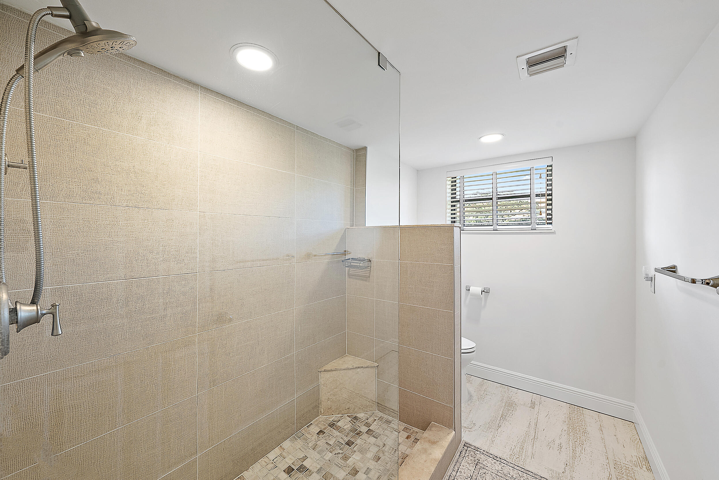 16647 Traders Crossing North, Unit 126 Jupiter, FL 33477 - Photo 22 of 45 a bathroom with a shower toilet and sink