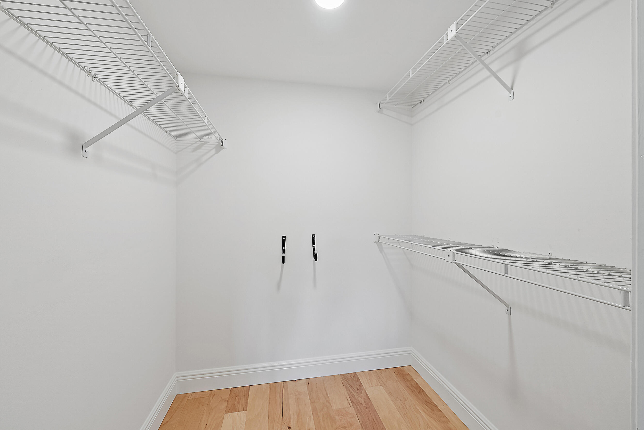 16647 Traders Crossing North, Unit 126 Jupiter, FL 33477 - Photo 24 of 45 a view of a room with racks on the wall