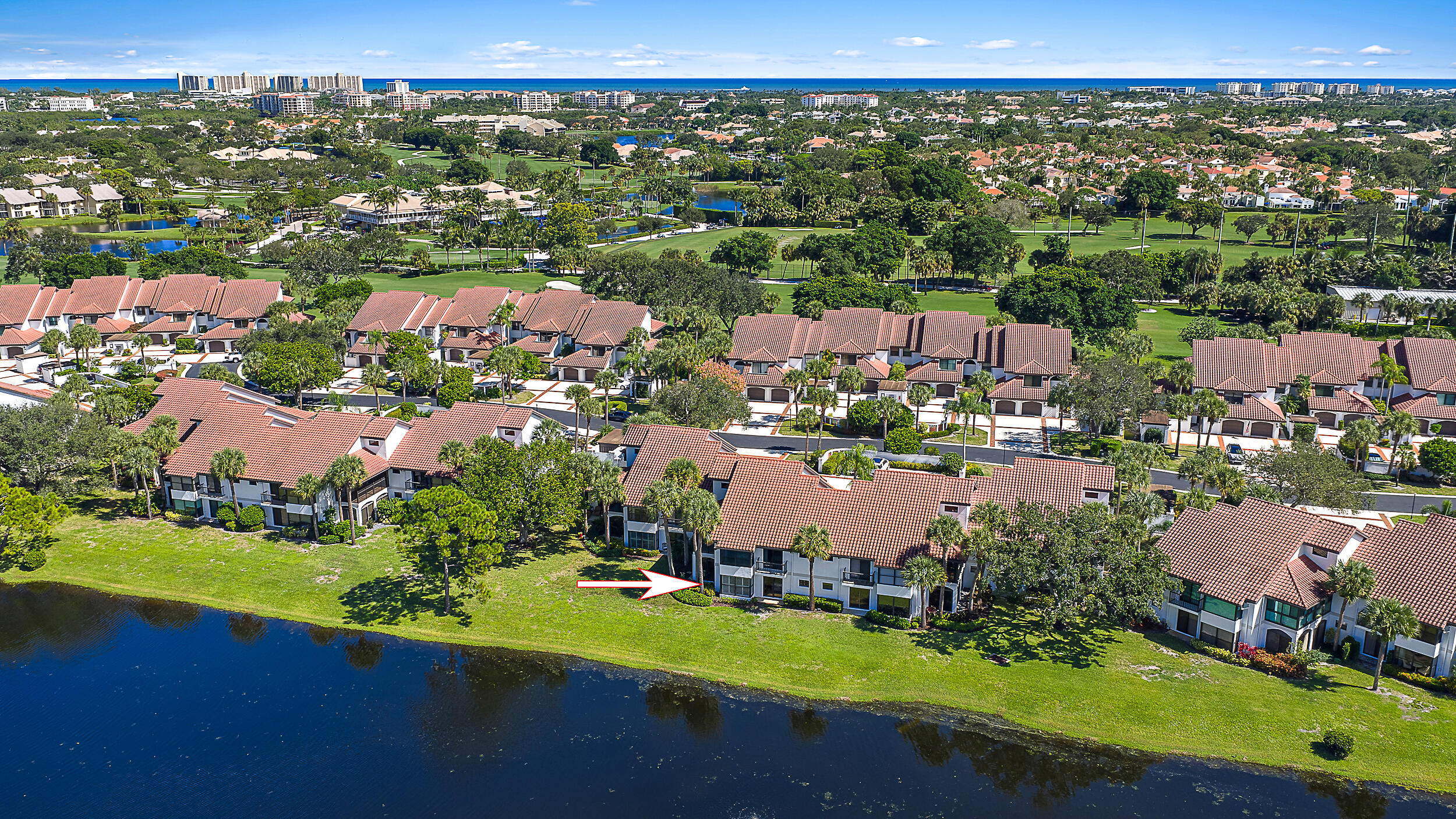 16647 Traders Crossing North, Unit 126 Jupiter, FL 33477 - Photo 38 of 45 an aerial view of a city with lots of residential buildings lake and ocean view
