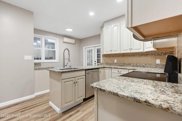 a kitchen with granite countertop sink and cabinets