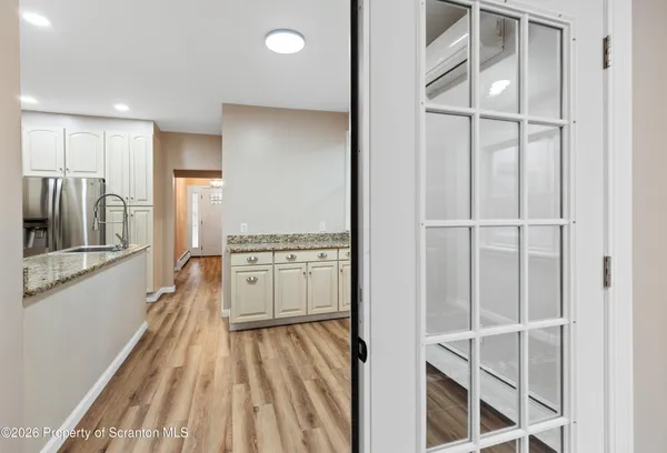 a kitchen with white cabinets and stainless steel appliances