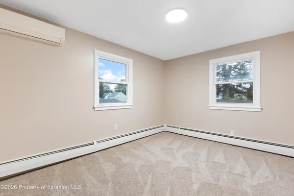 a view of a big room with window and closet