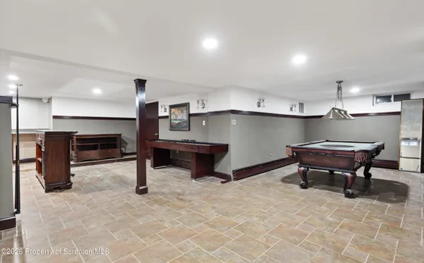 a kitchen with refrigerator and chairs
