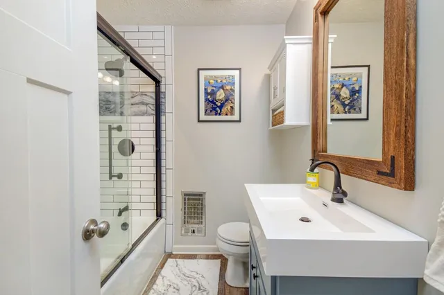 a bathroom with a sink toilet and shower