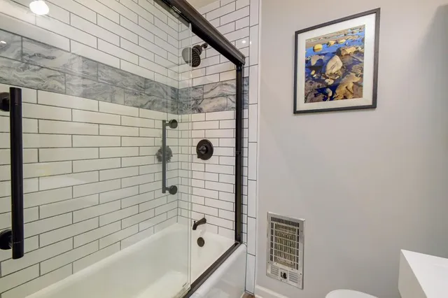 a bathroom with a bathtub and a shower