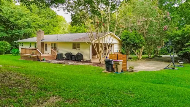 a view of a house with backyard porch and sitting area