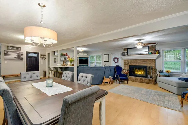 a view of a dining room with furniture and a fireplace