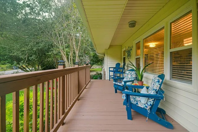 a balcony with chairs and wooden floor