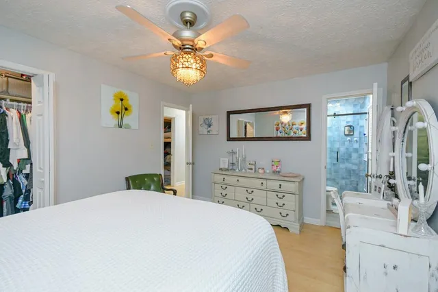 a bedroom with a bed and a chandelier