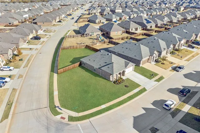 an aerial view of a residential houses with outdoor space