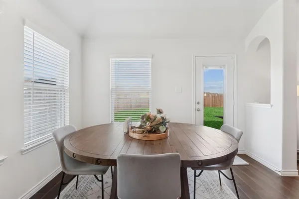 a view of a dining room with furniture window and wooden floor