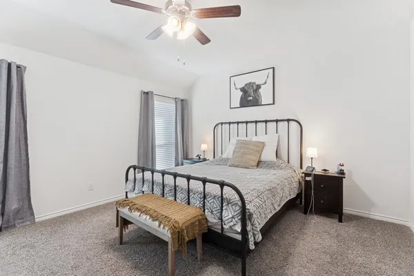 a bedroom with a bed and window